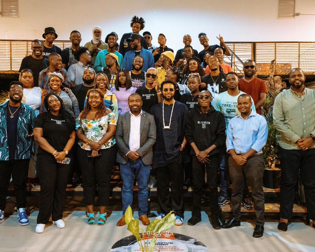 A group photo of participants and speakers at the MoTIV Uganda Marketspace during the BlacVolta Creatives & Creator Community Mixer