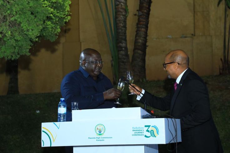 Minister Okello Oryem toasts with Rwanda’s High Commissioner to Uganda, Joseph Rutabana.