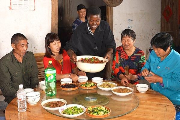 Adikin Rose Mary shares a meal with her family members