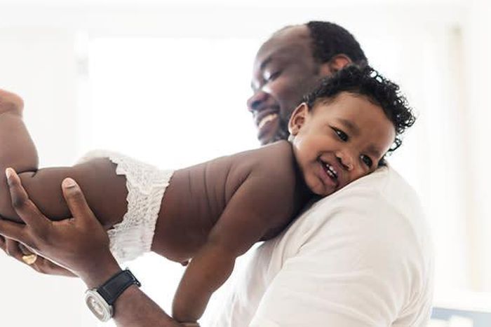 A father with a baby in daipers