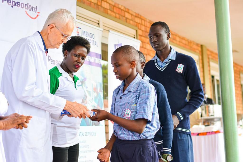 Doctor Ken Chapman handing out a care package to a school-goer