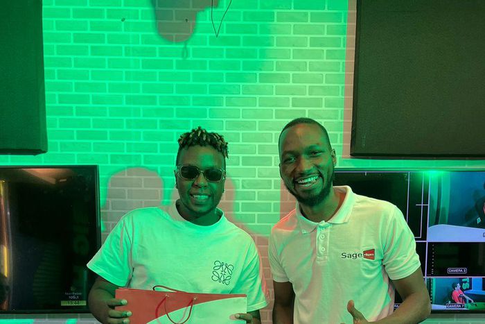 Next Radio's MC Casmir (left) with Stanley Ssempijja of Sage Buyers on Next Radio