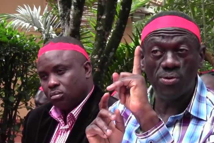 Lukwago (behind) and Besigye