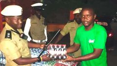 SSP Rogers Nsereko Kauma, the Kampala Metropolitan Traffic Police Commander recieving the refreshementfrom CCBU's Kirunda Magoola