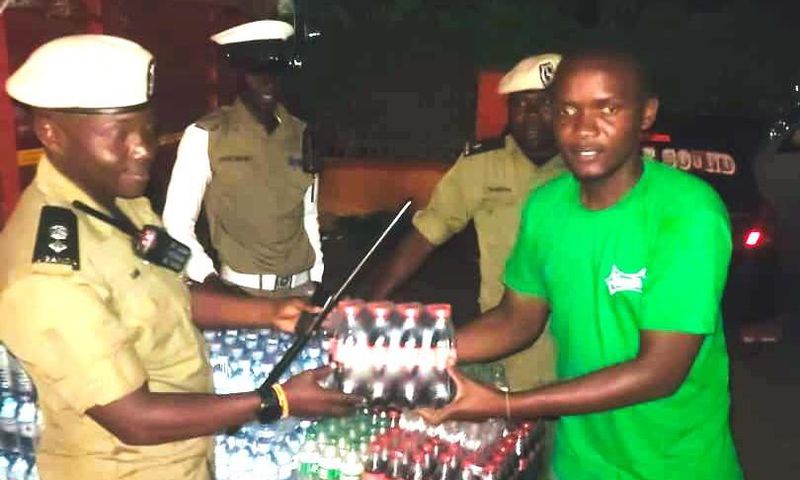 SSP Rogers Nsereko Kauma, the Kampala Metropolitan Traffic Police Commander recieving the refreshementfrom CCBU's Kirunda Magoola