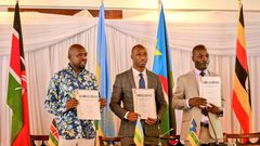 Hon. Kipchumba Murkomen (Cabinet Secretary, Ministry of Roads and Transport, Kenya), Hon. Jimmy Gasore (Minister of Infrastructure, Rwanda), and Hon. Fred Byamukama (Uganda's State Minister for Transport) display a signed report following the Joint Min...