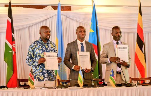 Hon. Kipchumba Murkomen (Cabinet Secretary, Ministry of Roads and Transport, Kenya), Hon. Jimmy Gasore (Minister of Infrastructure, Rwanda), and Hon. Fred Byamukama (Uganda's State Minister for Transport) display a signed report following the Joint Min...