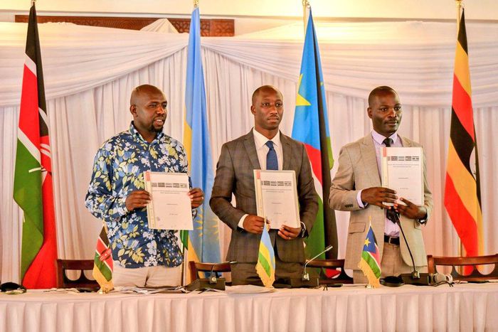 Hon. Kipchumba Murkomen (Cabinet Secretary, Ministry of Roads and Transport, Kenya), Hon. Jimmy Gasore (Minister of Infrastructure, Rwanda), and Hon. Fred Byamukama (Uganda's State Minister for Transport) display a signed report following the Joint Min...
