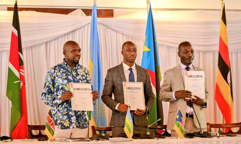 Hon. Kipchumba Murkomen (Cabinet Secretary, Ministry of Roads and Transport, Kenya), Hon. Jimmy Gasore (Minister of Infrastructure, Rwanda), and Hon. Fred Byamukama (Uganda's State Minister for Transport) display a signed report following the Joint Min...