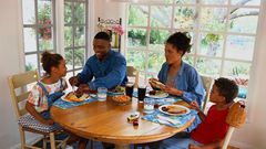Family sharing a meal/Courtesy/Yahoo Life