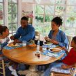 Family sharing a meal/Courtesy/Yahoo Life