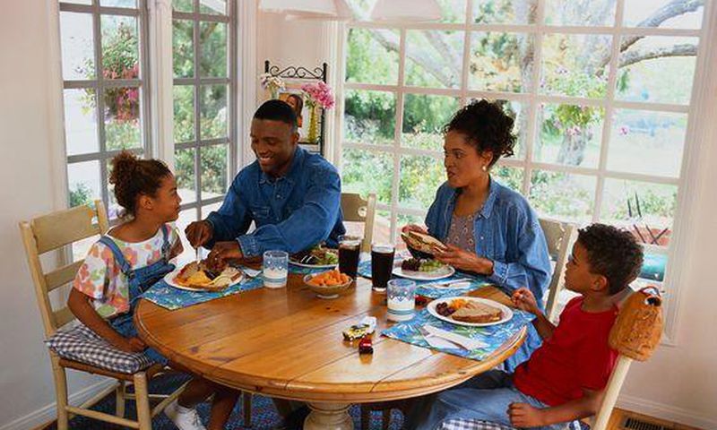 Family sharing a meal/Courtesy/Yahoo Life