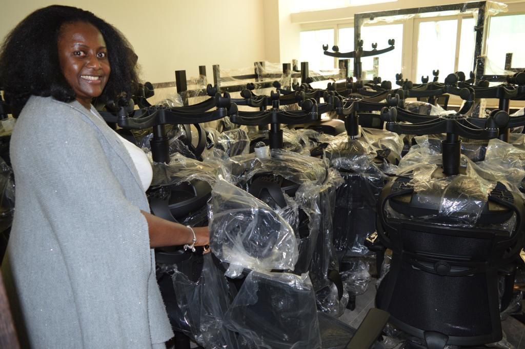 PS Ssali showing off the some the ministry's new furniture