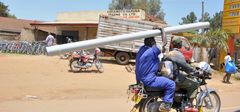 Man transporting water pipe on boda boda/Courtesy