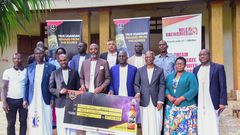 NBL Head of Legal and Corporate Affairs, Mr Emmauel Njuki (3rd left) handing over the dummy check to Busoga PM Muvawala