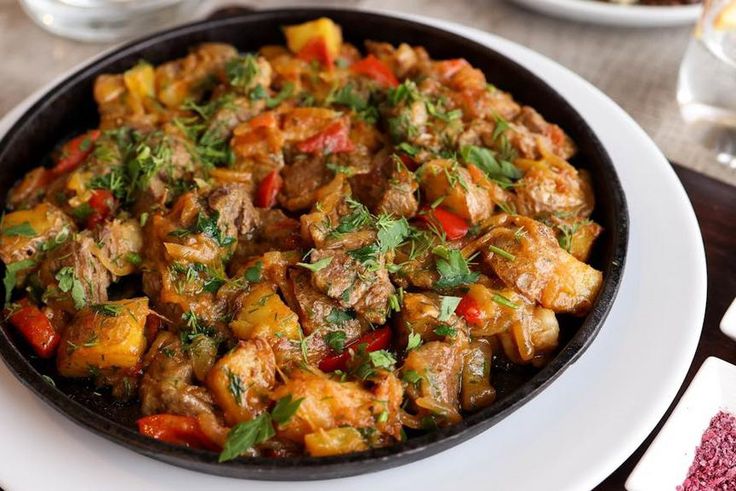 Beef stew garnished with cilantro [Image Credit: Valeria Boltneva]