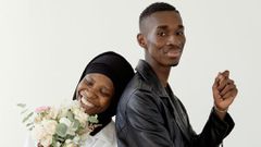 Beautiful couple smiling while standing together [Image: Darina Belonogova]