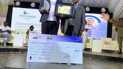Ssentogo posing with his award. Besides him is the Iganga District Resident Judge, Justice David Batema