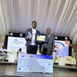 Ssentogo posing with his award. Besides him is the Iganga District Resident Judge, Justice David Batema
