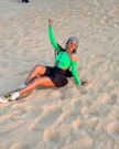 Spice Diana in sneakers, a black skirt, and a green top for her desert activities