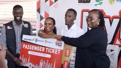 Nahurira Ivan and his guardian Kamugisha Martha congratulated by Christine Mawadri, the NRG Director of Partnerships
