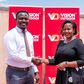 Next Media’s Chief Marketing Officer, Danze Edwin and Vision Group’s Head of Marketing and Communication, Lorraine Tukahirwa shake hands