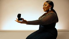 AI-generated image of an African woman, elegantly kneeling in a stylish dinner dress