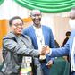 The ICOB president Uganda chapter, Grace Mugabirwe Mutebile (left) with State Minister for Trade Industry and Cooperatives David Bahati (Right) at the convention in Kabale Town.