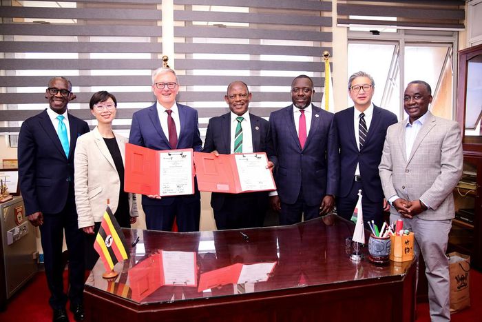 The Vice Chancellor Prof. Barnabas Nawangwe (Centre) and UWO President Dr. Alan Shepard (3rd Left) show off the signed MoU as Left to Right: UWO's Dr. Opiyo Oloya and Dr. Lily Cho as well as University Secretary Yusuf Kiranda, UWO's Dr. John Yoo and He...
