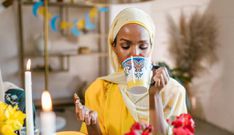 Woman in yellow hijab eating and drinking during Ramdhan [Image Credit: RDNE Stock Project]