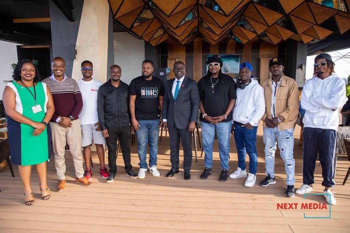 Next Media Group CEO Kin Kariisa(center) with the audio producers and songwriters