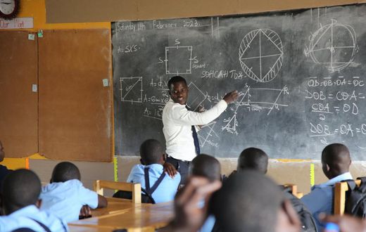 A head tecaher at Mbazzi primary School carrying out a class session