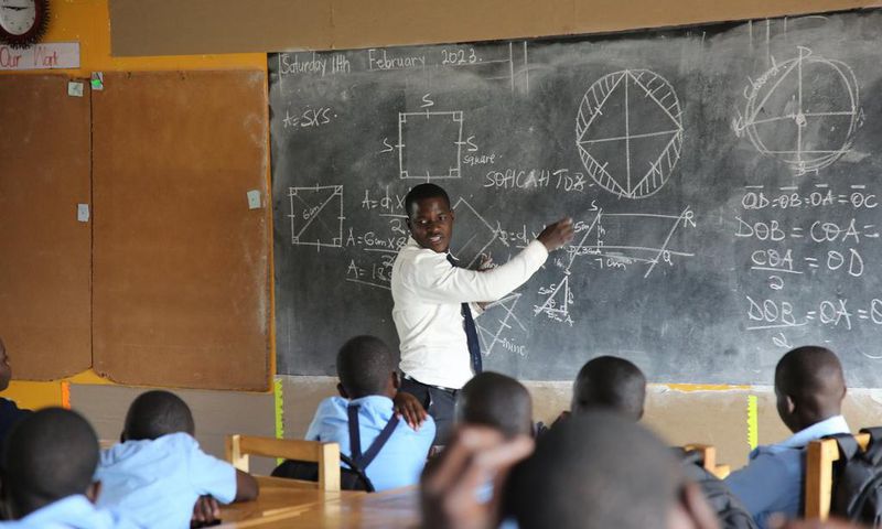 A head tecaher at Mbazzi primary School carrying out a class session