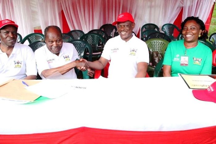 Dr. Martin Aliker (2nd L) shakes hands with the Vice Chancellor, Prof. Barnabas Nawangwe (2nd R) at the successful conclusion of the Second Edition of the Makerere University Endowment Fund (MakEF) Run (MakRun) on Sunday, March 25, 2018 as Prof. Willia...