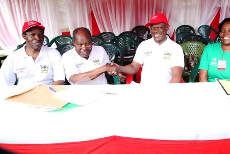 Dr. Martin Aliker (2nd L) shakes hands with the Vice Chancellor, Prof. Barnabas Nawangwe (2nd R) at the successful conclusion of the Second Edition of the Makerere University Endowment Fund (MakEF) Run (MakRun) on Sunday, March 25, 2018 as Prof. Willia...
