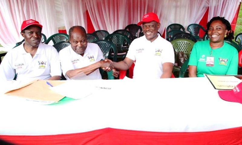 Dr. Martin Aliker (2nd L) shakes hands with the Vice Chancellor, Prof. Barnabas Nawangwe (2nd R) at the successful conclusion of the Second Edition of the Makerere University Endowment Fund (MakEF) Run (MakRun) on Sunday, March 25, 2018 as Prof. Willia...