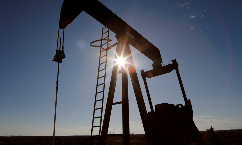 FILE PHOTO: The sun is seen behind a crude oil pump jack in the Permian Basin in Loving County, Texas, U.S., November 22, 2019. REUTERS/Angus Mordant