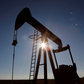 FILE PHOTO: The sun is seen behind a crude oil pump jack in the Permian Basin in Loving County, Texas, U.S., November 22, 2019. REUTERS/Angus Mordant