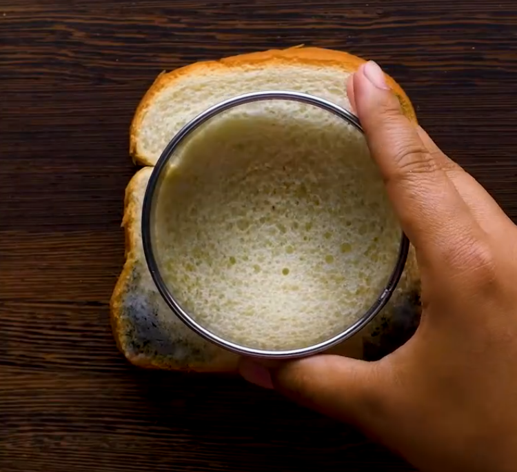 Cutting out a patch of bread to use as a scrub