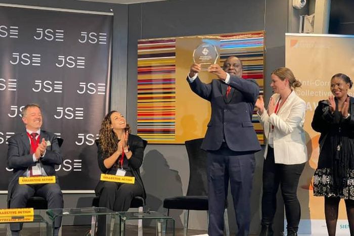 Receiving the award on behalf of Uganda