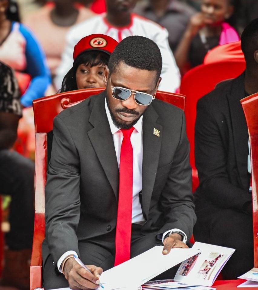 Bobi Wine signing the eulogies book