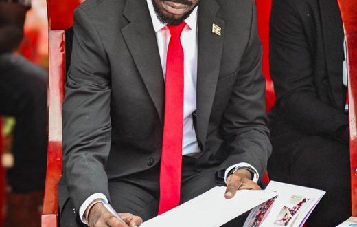Bobi Wine signing the eulogies book
