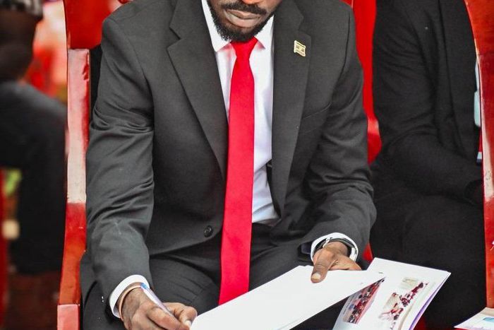 Bobi Wine signing the eulogies book