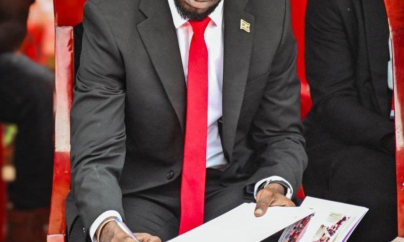 Bobi Wine signing the eulogies book
