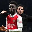Arsenal manager Mikel Arteta celebrates with goalscorer, Bukayo Saka