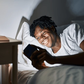 Black man in bed [Shutterstock]