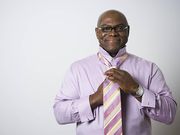 Portrait of a businessman tying his tie