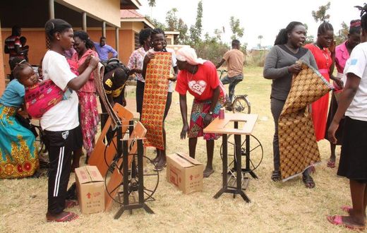 Beneficiaries-of-the-tailoring-training-just-after-receiving-their-start-up-kits-including-sewing-machines-fabric-and-other-items