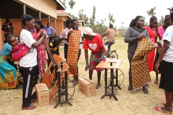 Beneficiaries-of-the-tailoring-training-just-after-receiving-their-start-up-kits-including-sewing-machines-fabric-and-other-items