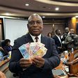 John Mushayavanhu, Governor of the Reserve Bank of Zimbabwe, presents the new national currency Zimbabwe Gold, or ZiG.Columbus Mavhunga/picture alliance/Getty Images